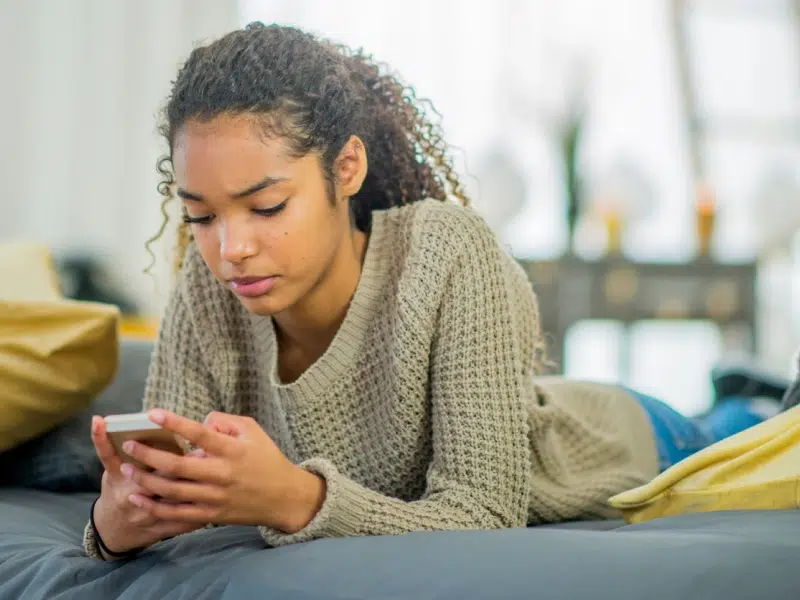 Teen girl looking at her phone