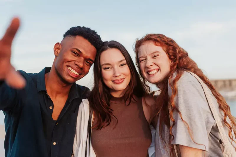 Group of young adults smiling, vibing