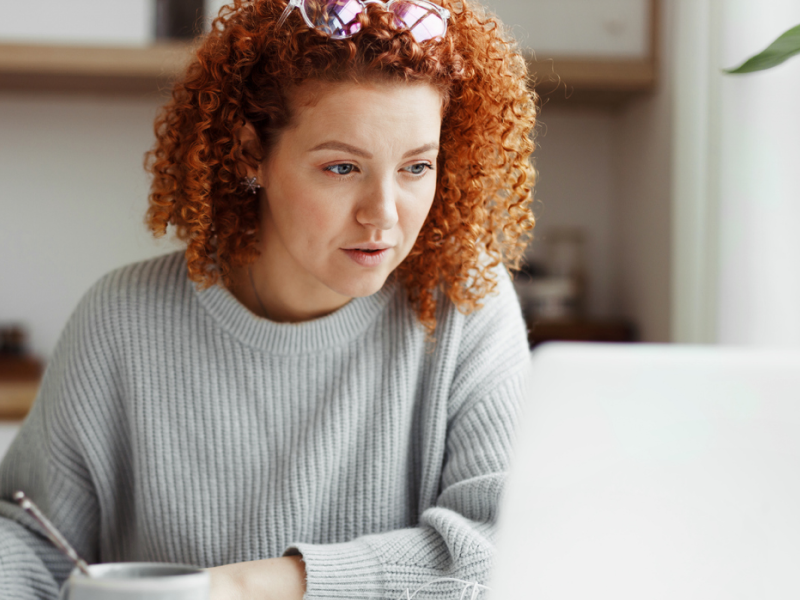 A young woman reads these Charlie Health IOP reviews to see if it's right for her.