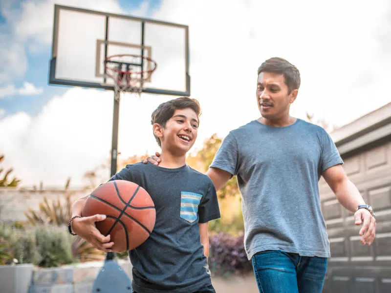 Parent and teen practice self-soothing by playing basketball
