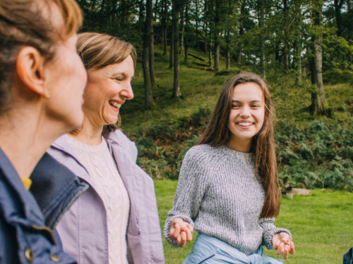 A teenager is on a walk with her mothers. She is using the PLEASE DBT Skill to prioritize self-care amid emotional overwhelm.