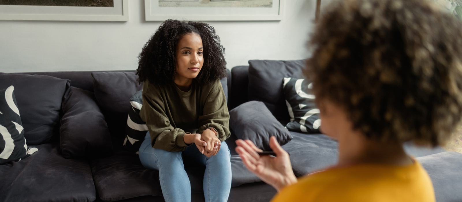 A teenager sits in a therapy room. She is doing DBT therapy for PTSD from narcissistic abuse.