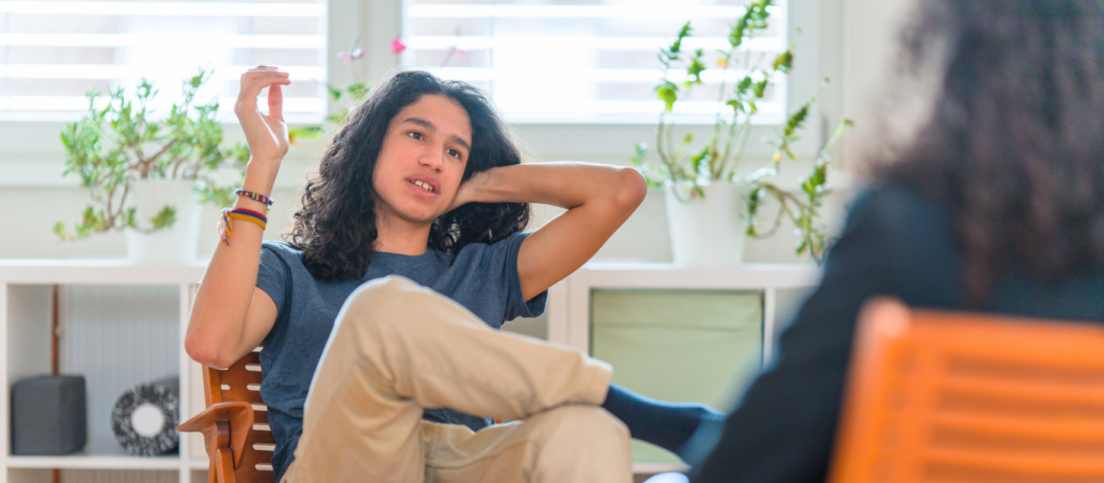 A young male sits in therapy. He is exploring the why in professional support for his separation anxiety.