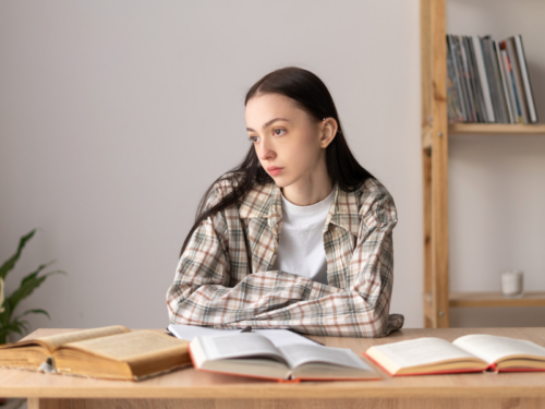 A female teenager sits at her desk doing homework. She has 1 type of ADHD, there are actually 3 types of ADHD in total.