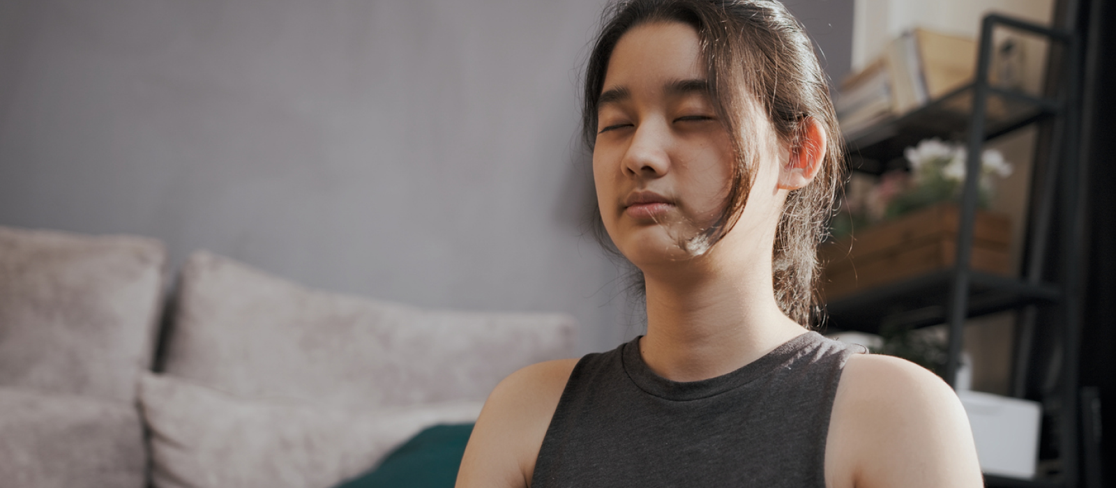 A young teenager practices somatic breathing.