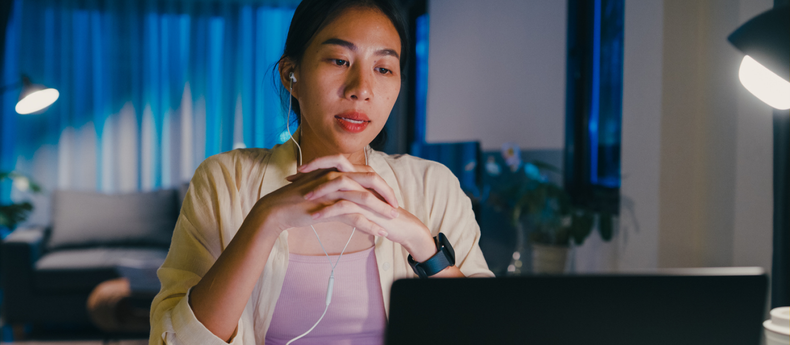 A young women is facing her fears of therapy by being patient with herself during her first virtual therapy session.