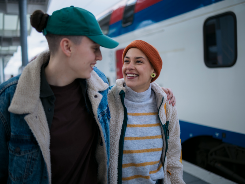 A young couple walks away from the train. They are experiencing separation anxiety in their relationship and are interested in ways to cope.