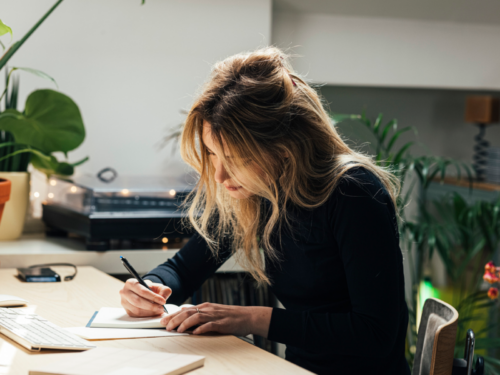 A young woman uses journaling prompts to help her process a trauma anniversary.