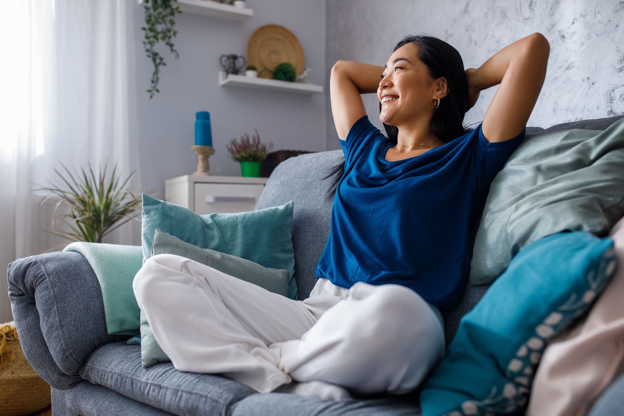 Woman relaxing on her couch practicing self-care