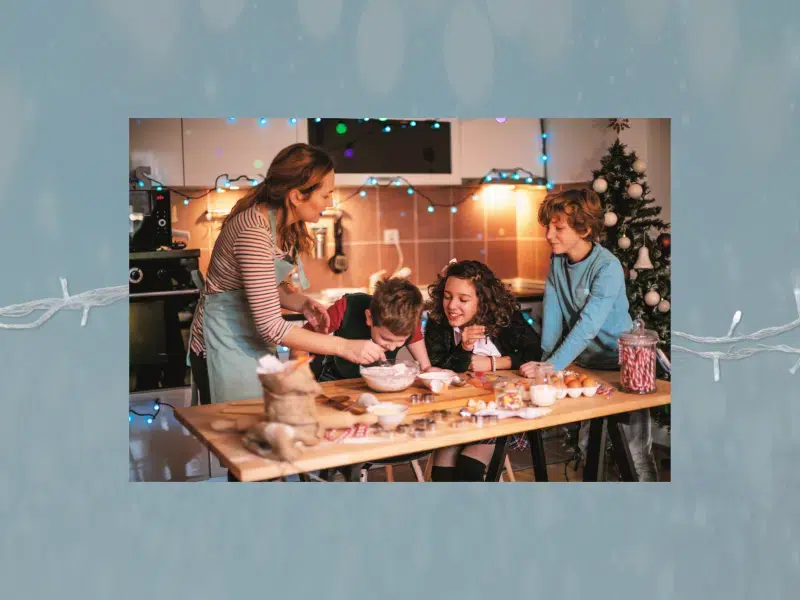 Family around a table making Christmas cookies