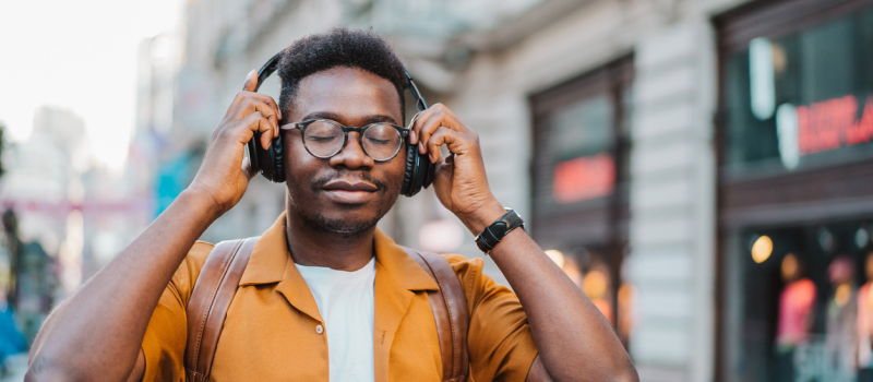 A person with depression puts on headphones to listen to a mindfulness meditation to manage depression.