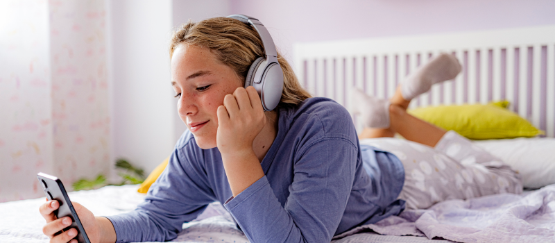 A teenage girl distracts herself with listening to music to stop a mental spiral.