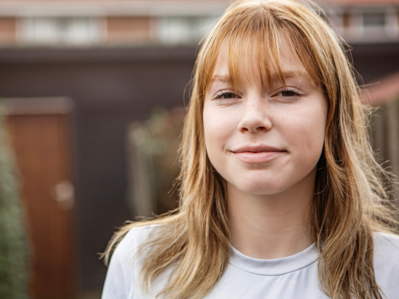 A woman with orange hair smiles as she is able to manage her ADHD using DBT skills.