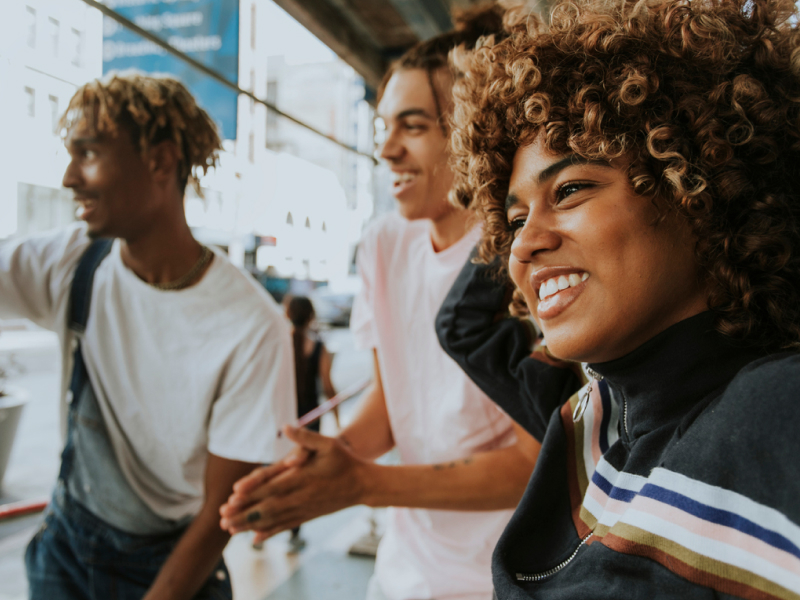 A group of people sit around smiling after a session of group therapy for borderline personality disorder.