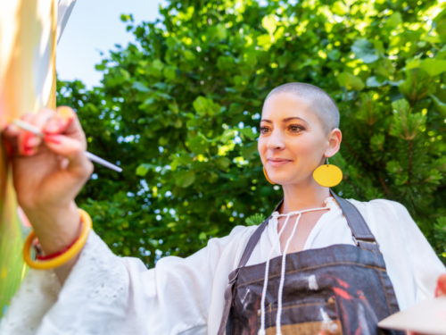 A young woman does art therapy to help cope with depression.