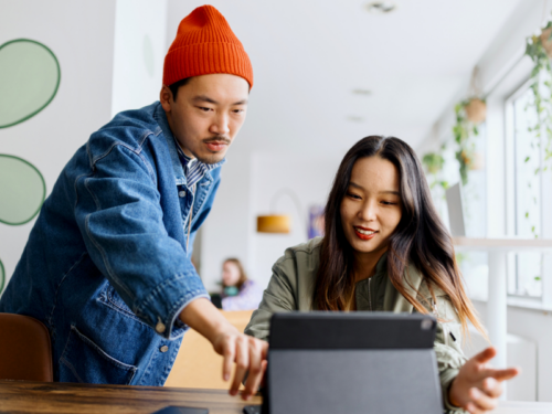 Two employees work for a company that understands the intersection of mental health, wellness, and DEI in the workplace.