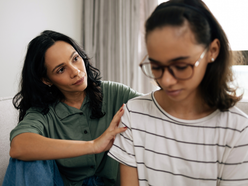 A mother sits with her daughter who is in CBT to help her manage oppositional defiant disorder.