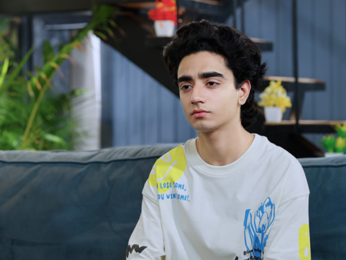 Teen sitting on couch while he is high