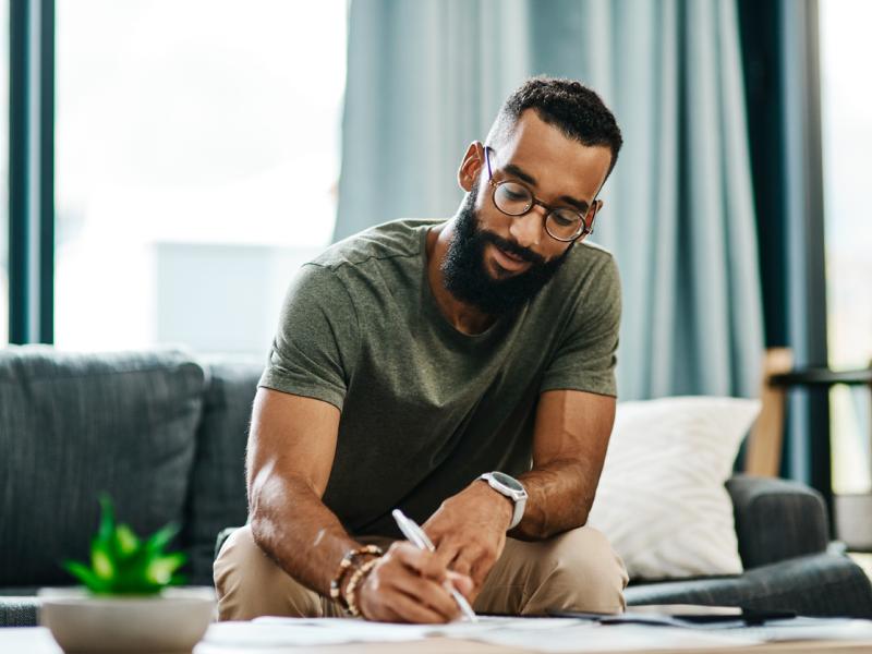 A young man is breaking free from the past by using effective strategies, like journaling, to embrace the present and future.