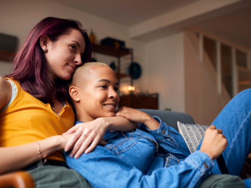 A young couple sits on the couch after taking an abandonment issues quiz.