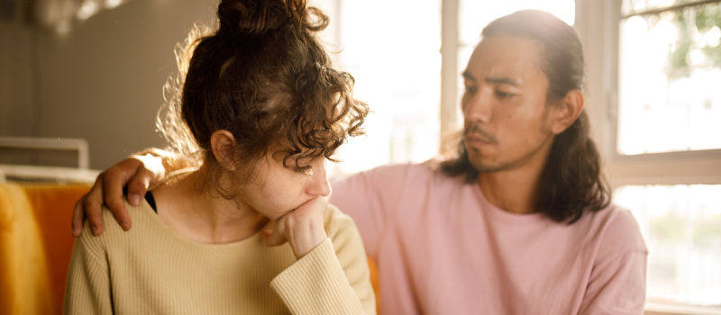 A man comforts his partner who is living with bipolar disorder.