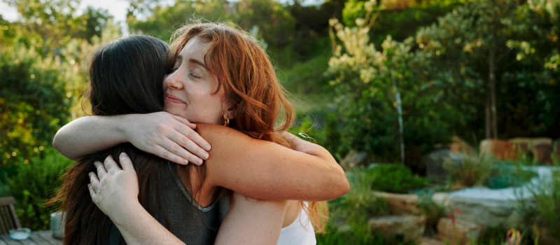 A woman gets emotional support from her friend.