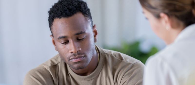 A man learns about the role of medications in treating cannabis addiction from a doctor.