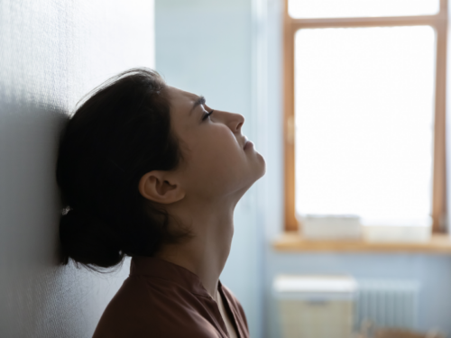 A woman feels distressed, which may be a sign of emotional trauma.
