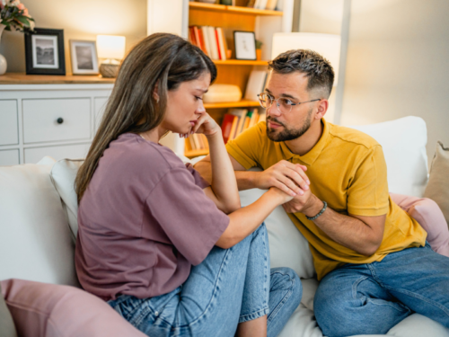 A man comforts his partner who has bipolar disorder.