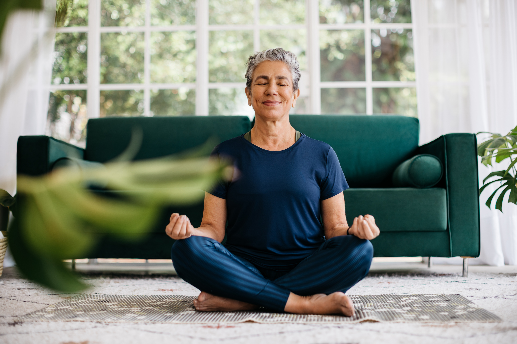 Woman doing a breathing workout to achieve relaxation, peace, mindfulness, and ultimately break her functional freeze