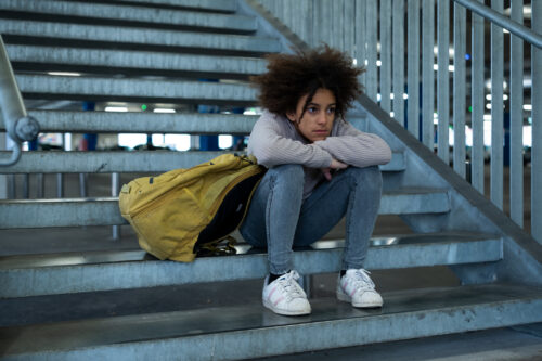 Sad girl sitting on stairs