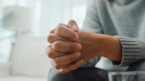 Close up of hands in a position of listening and caring