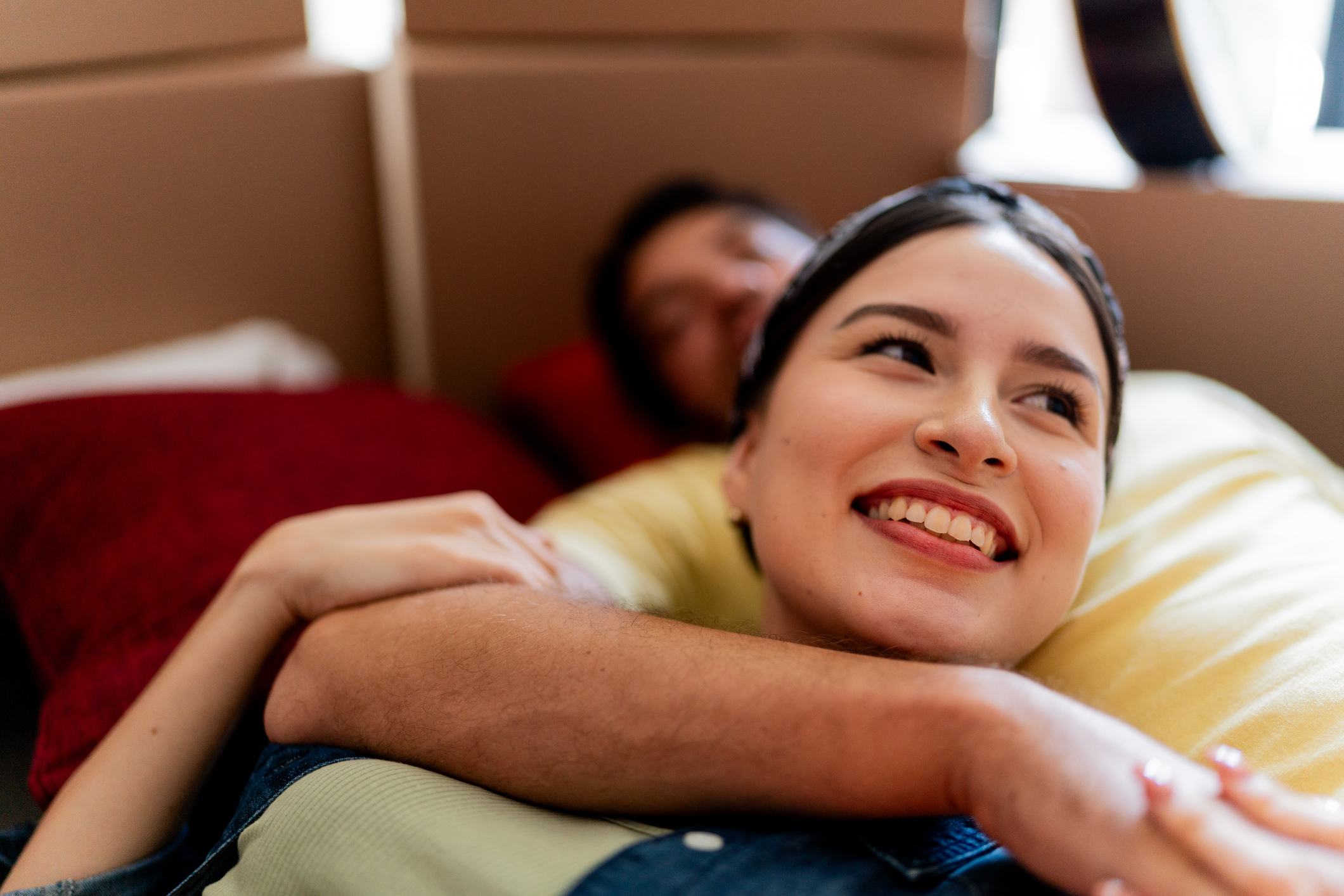 Young woman lying on husband lap and looking away dreaming at a new  lease on life