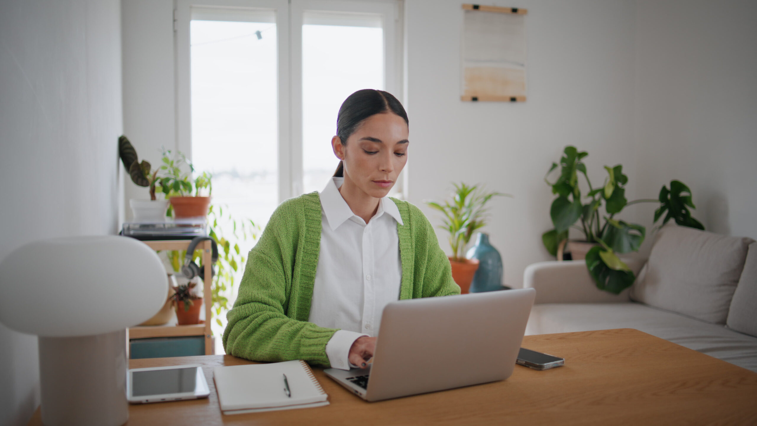 Focused blogger typing laptop at home close up and able to manage her workload with her life outside of work.