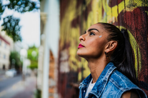 Mid adult woman contemplating and overthinking while looking away outdoors
