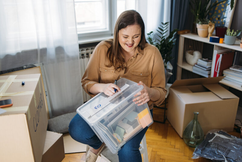 Woman happy to be organizing and getting rid of items
