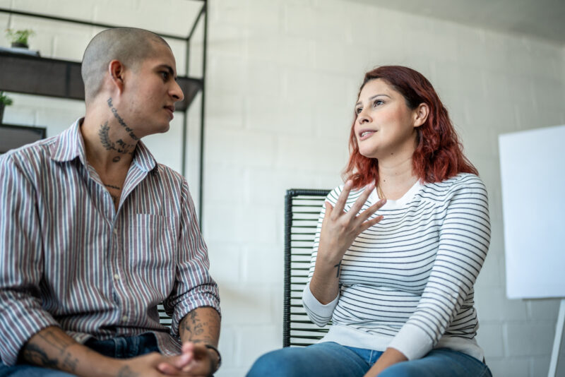 People talking during a psychotherapy or group therapy practicing person-centered therapy