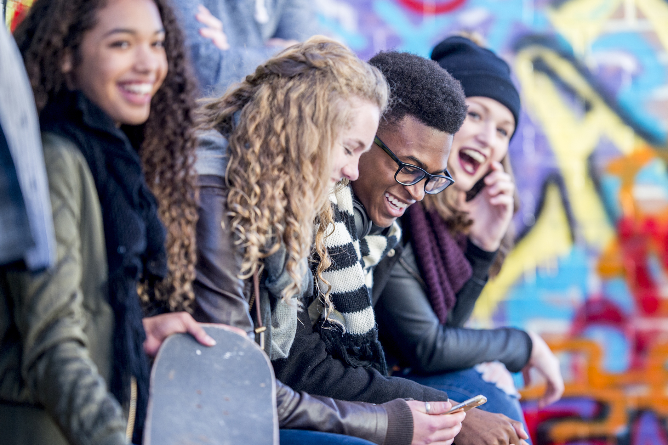 A group of teens hanging out with a vape.