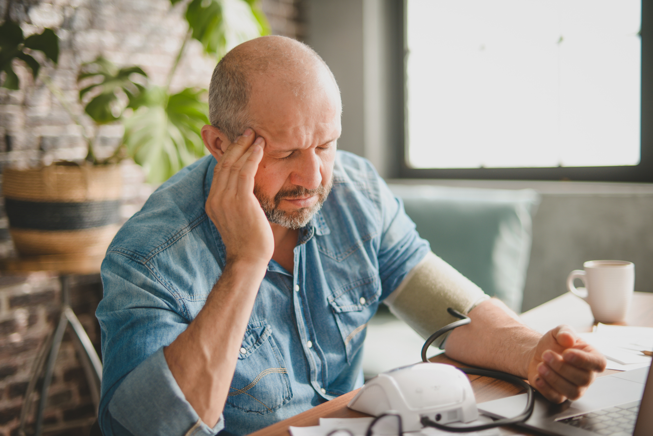 Man wondering where his blood pressure is coming from and thinking it might be a result of his anxiety.