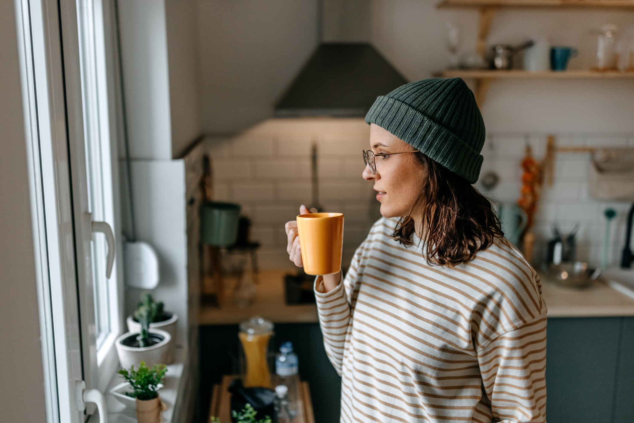 Woman enjoying her coffee, as she's able to manage her OCD and eating disorder.