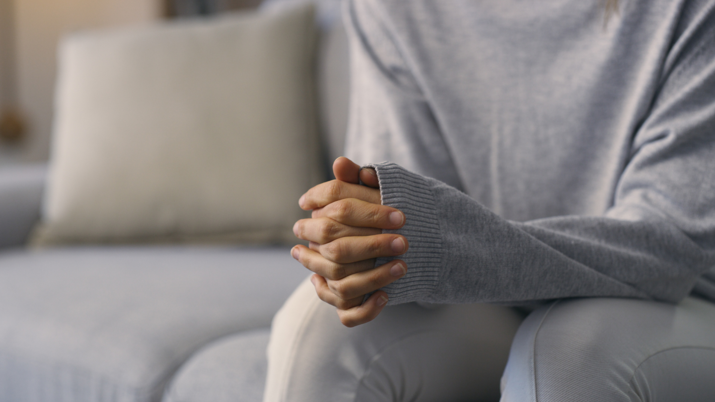 Woman sitting in therapy discussing her self-harm.