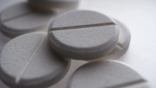 Close-up of multiple small pills, representing the risk of dependency and misuse associated with Xanax.