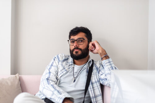 Man sitting with a thoughtful expression, representing someone reflecting on personal or family history of ADHD.