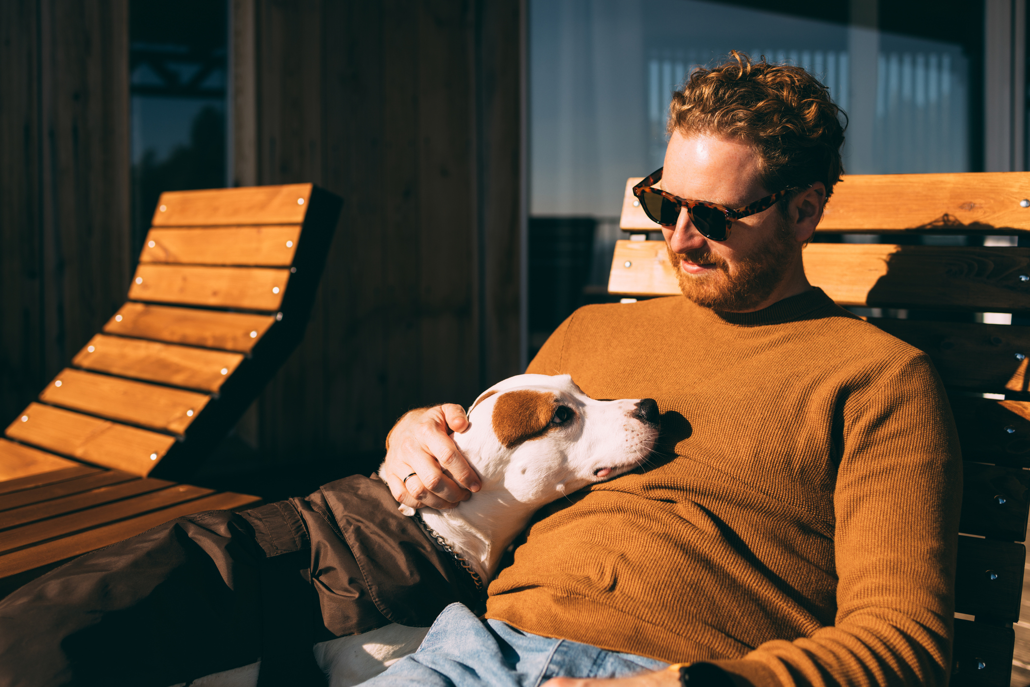 Man relaxing outside with his dog, symbolizing moments of peace that may be part of recovery from Xanax addiction.