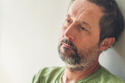 Older man staring blankly, illustrating emotional withdrawal or vulnerability that may emerge as narcissistic traits shift with age.