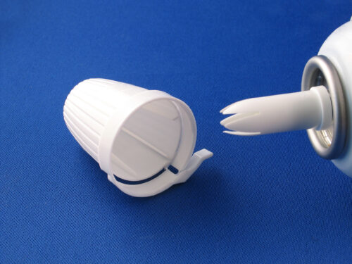 Close-up of a whipped cream canister with its cap removed, highlighting the equipment commonly misused when inhaling nitrous oxide, also known as “whippets.”