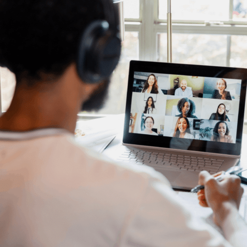 A young adult on a laptop in a virtual therapy session at Charlie Health