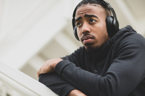 Man wearing headphones, looking thoughtful, reflecting on the emotional impact of going no contact.