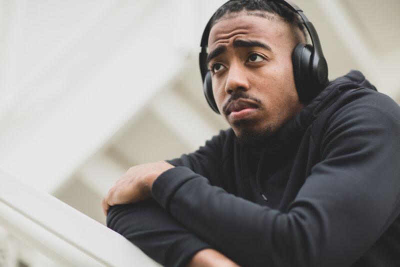 Man wearing headphones, looking thoughtful, reflecting on the emotional impact of going no contact.
