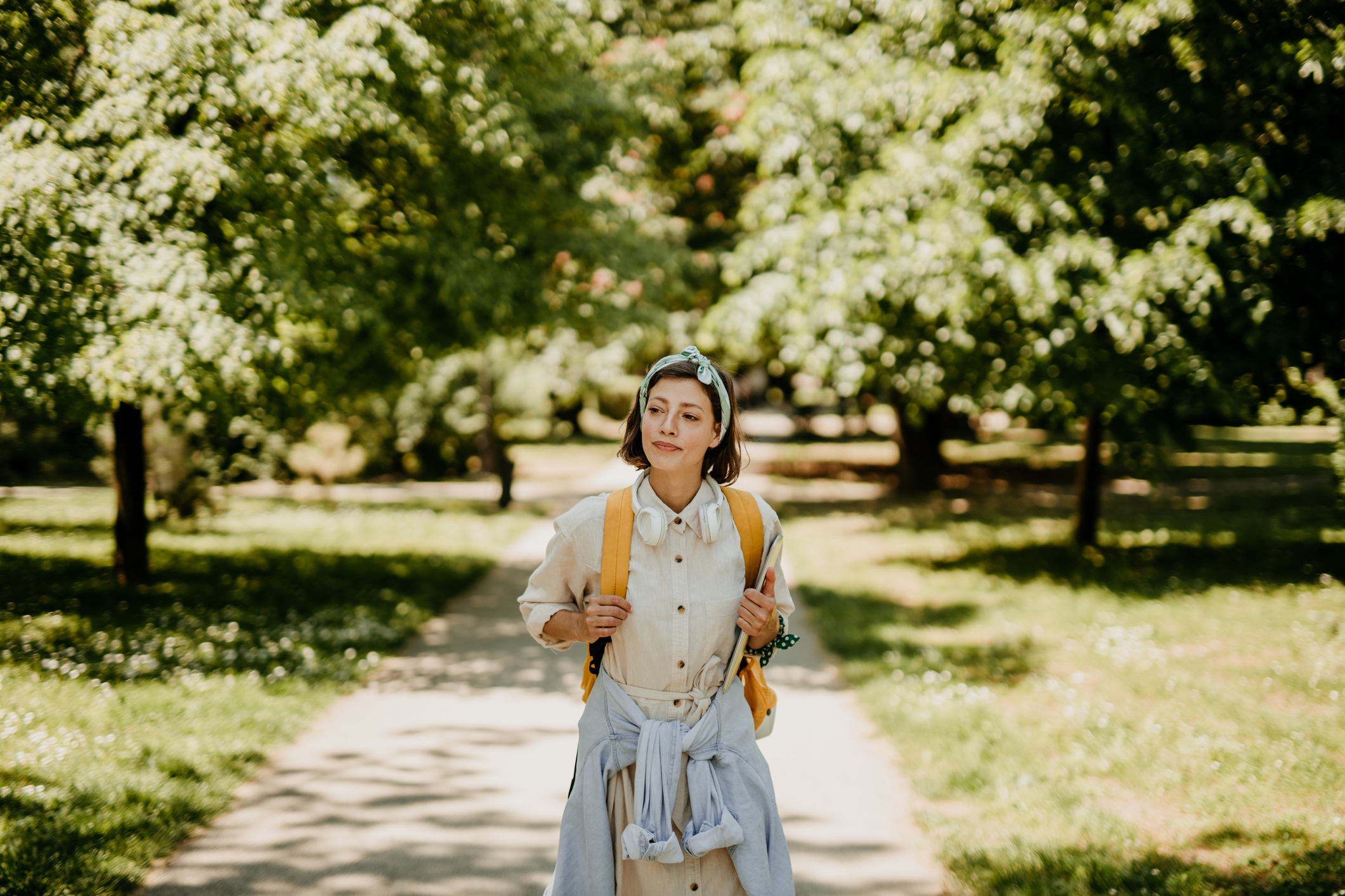 Woman walking with backpack, symbolizing how personal growth evolves over time in therapy sessions.